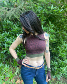 Organic cotton crop top, reddish brown fabric with geometric print, front side view on model in natural lighting.