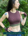Organic cotton crop top, reddish brown fabric with geometric print, front side view on model.