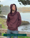 Organic cotton fleece unisex hoodie, reddish brown fabric with geometric print, front side view on male model.