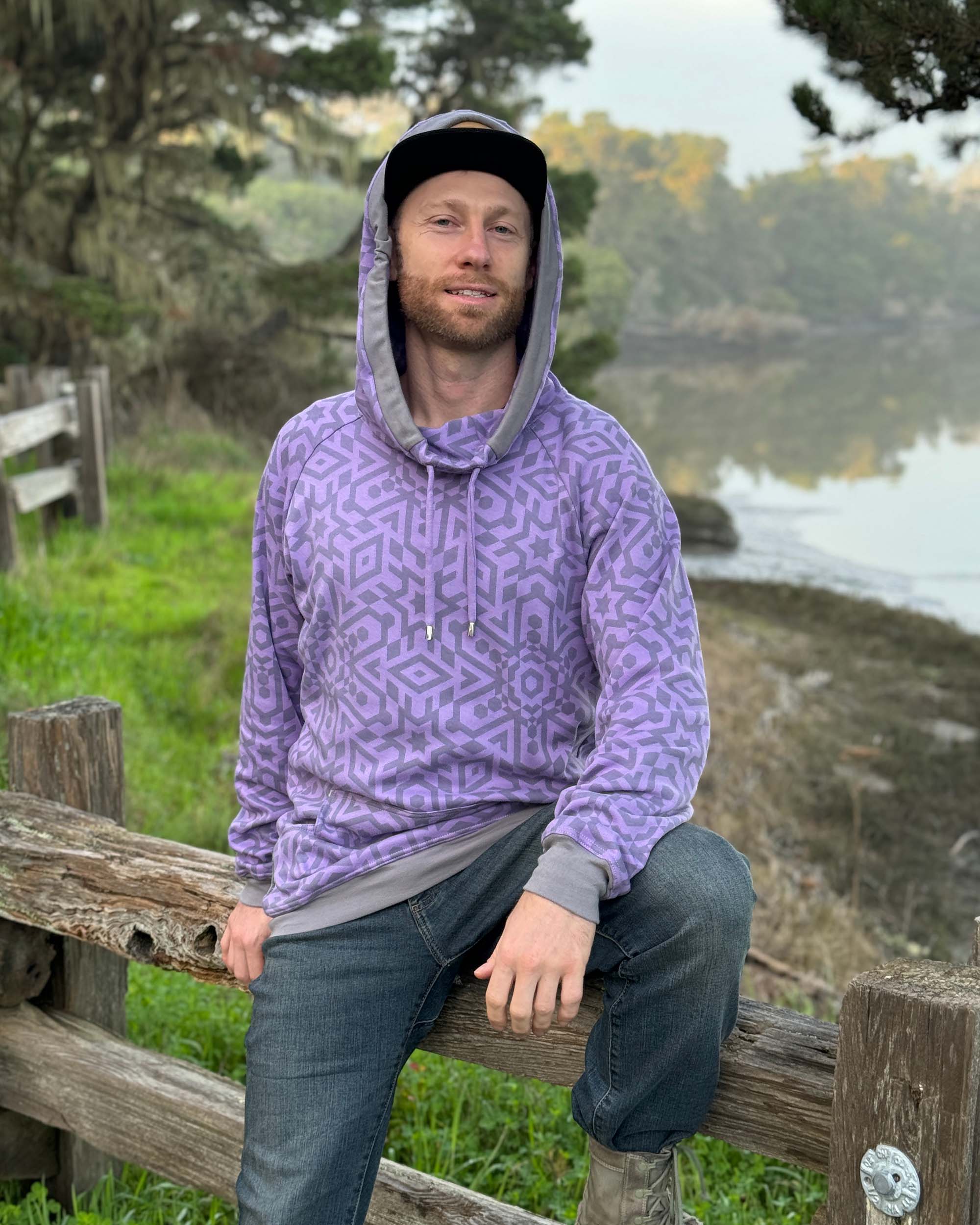 Organic cotton extra long unisex hoodie, lavender with geometric print, right view of male model.