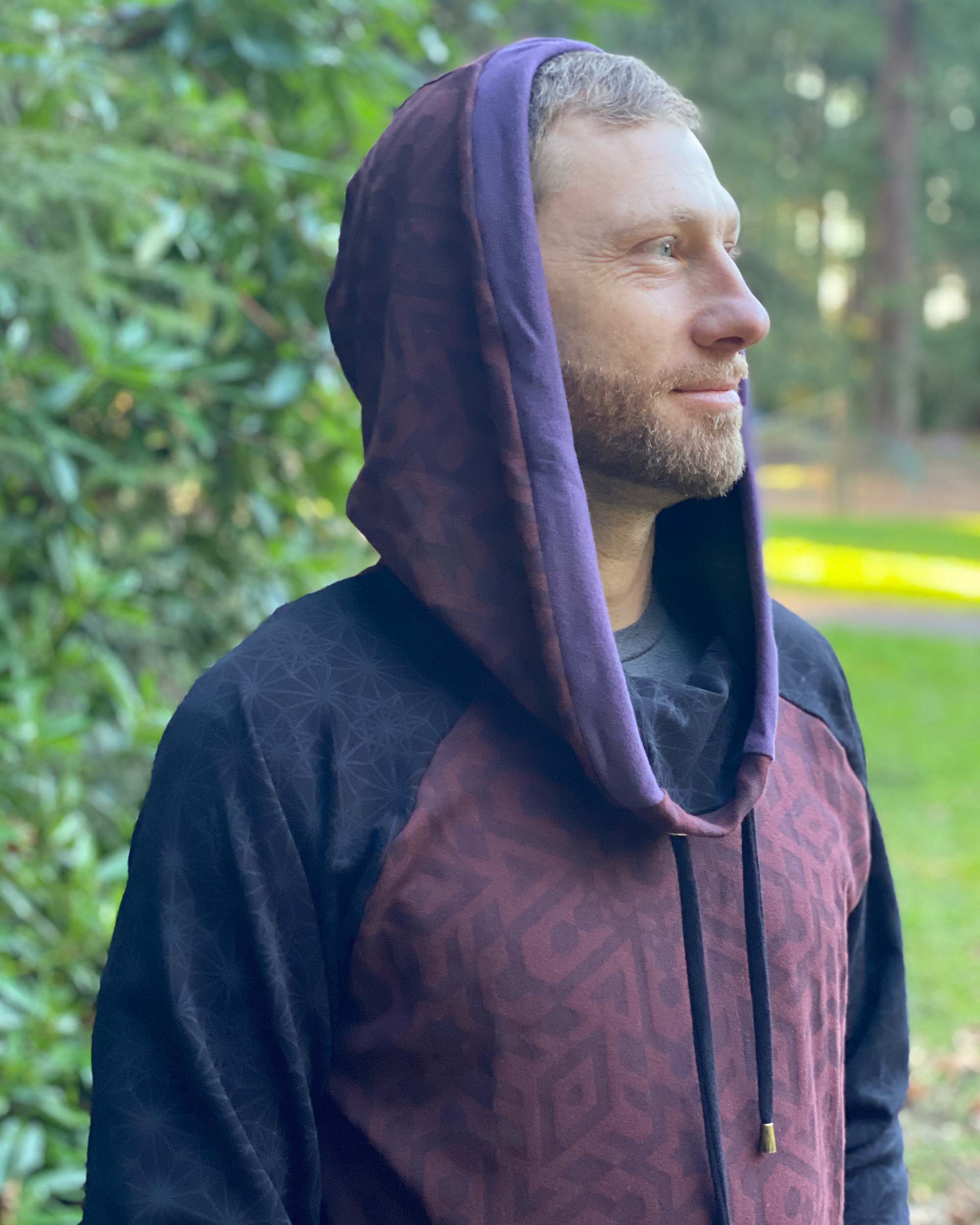 Organic cotton cowl hoodie, brown and black fabric with geometric print, detail view of hood.