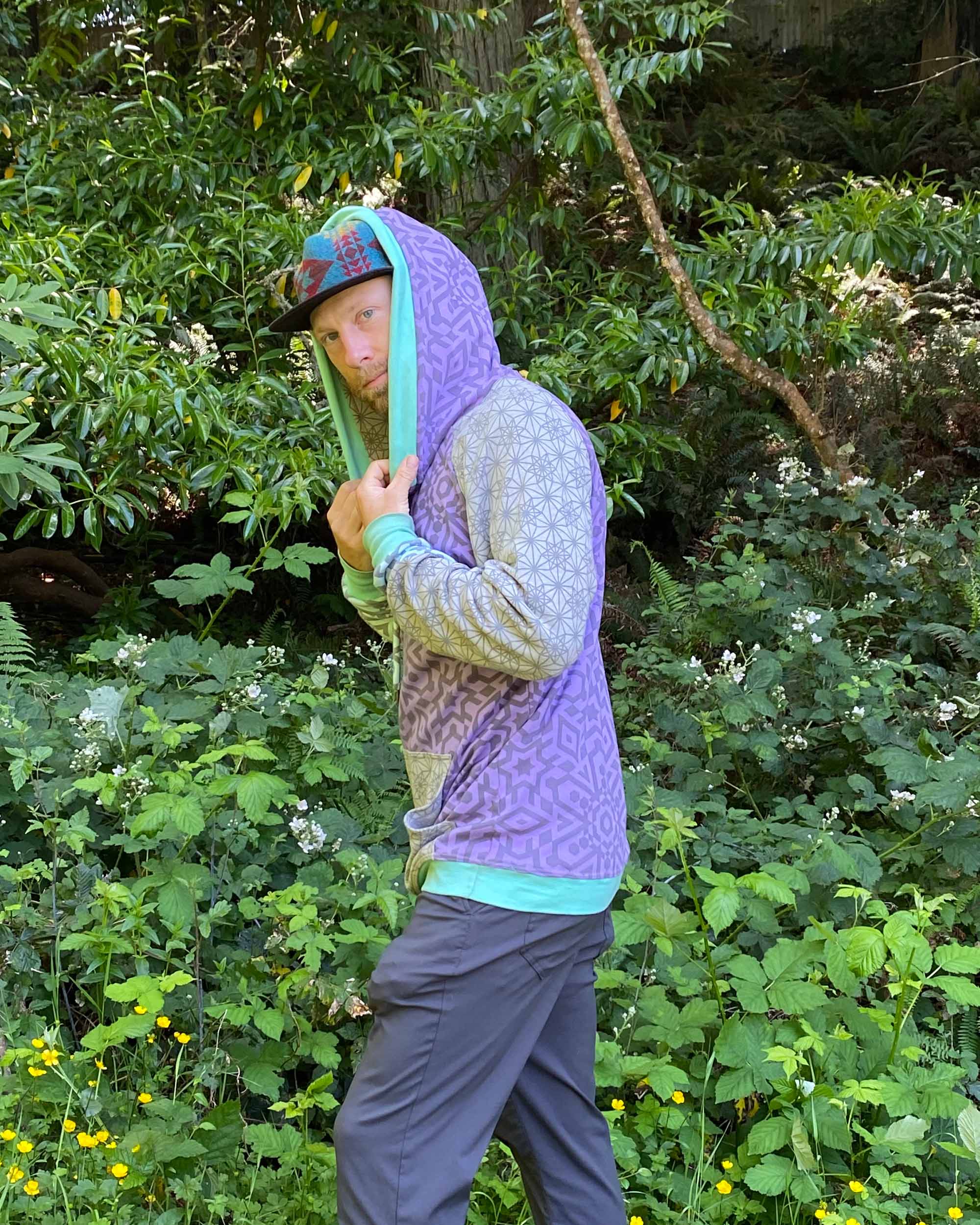 Organic cotton hoodie, lavender and grey fabric with geometric print, back  side on male model.