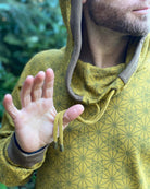 Organic cotton extra long unisex hoodie, yellow fabric with geometric print, detail close up of drawcord.