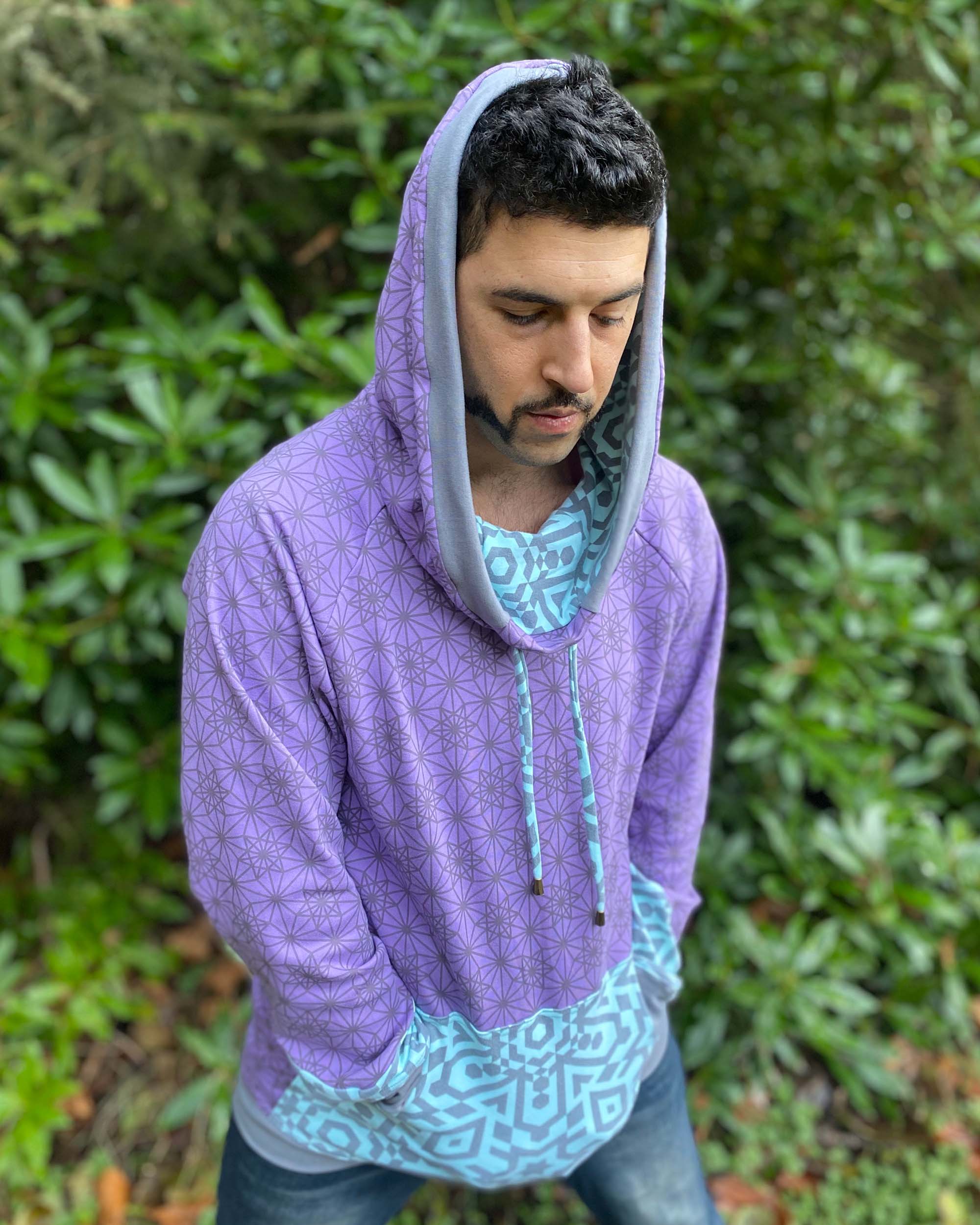 Organic cotton hoodie, lavender and blue fabric with geometric print, front view on male model.