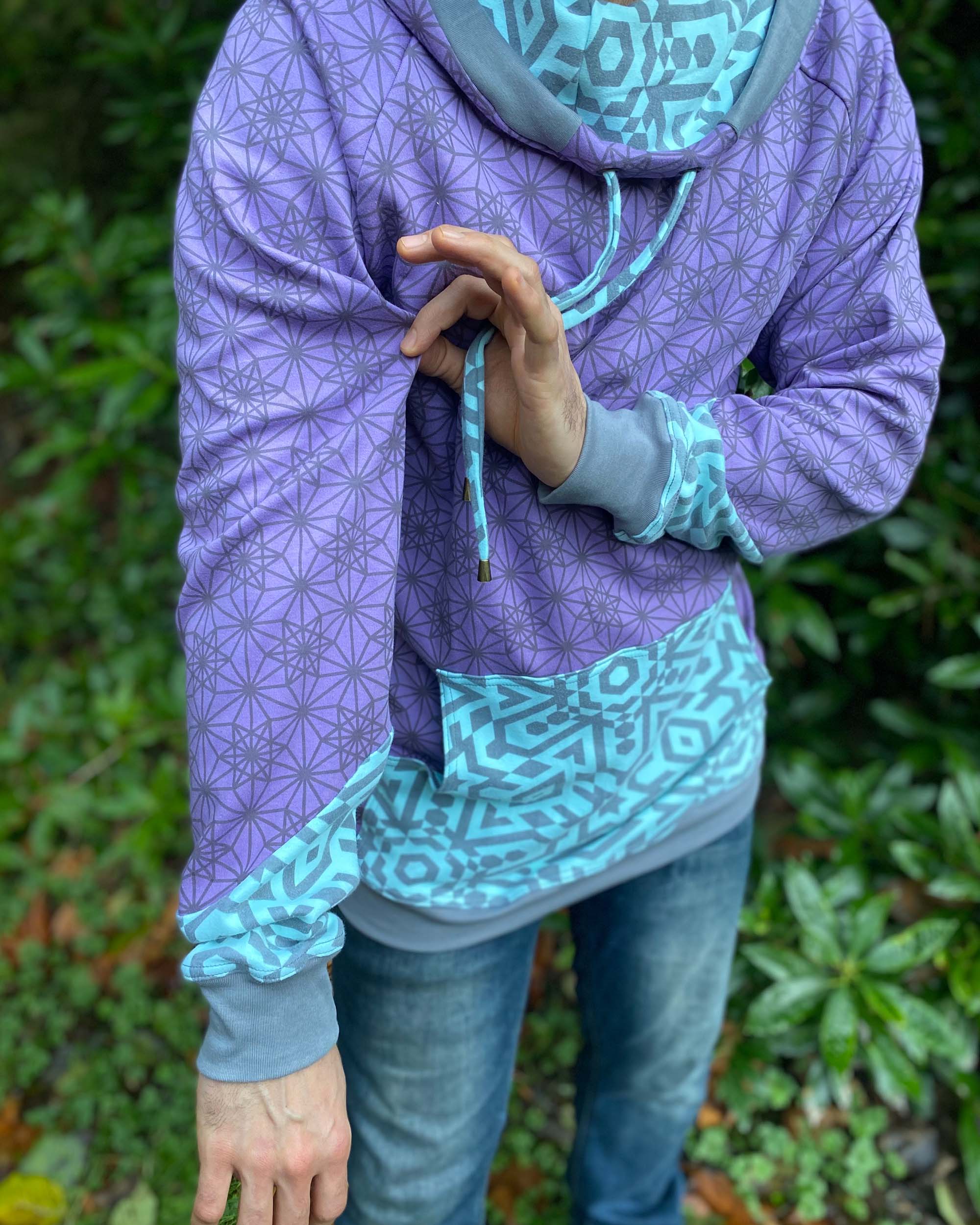 Organic cotton hoodie, lavender fabric with geometric print, detail view of sleeve.