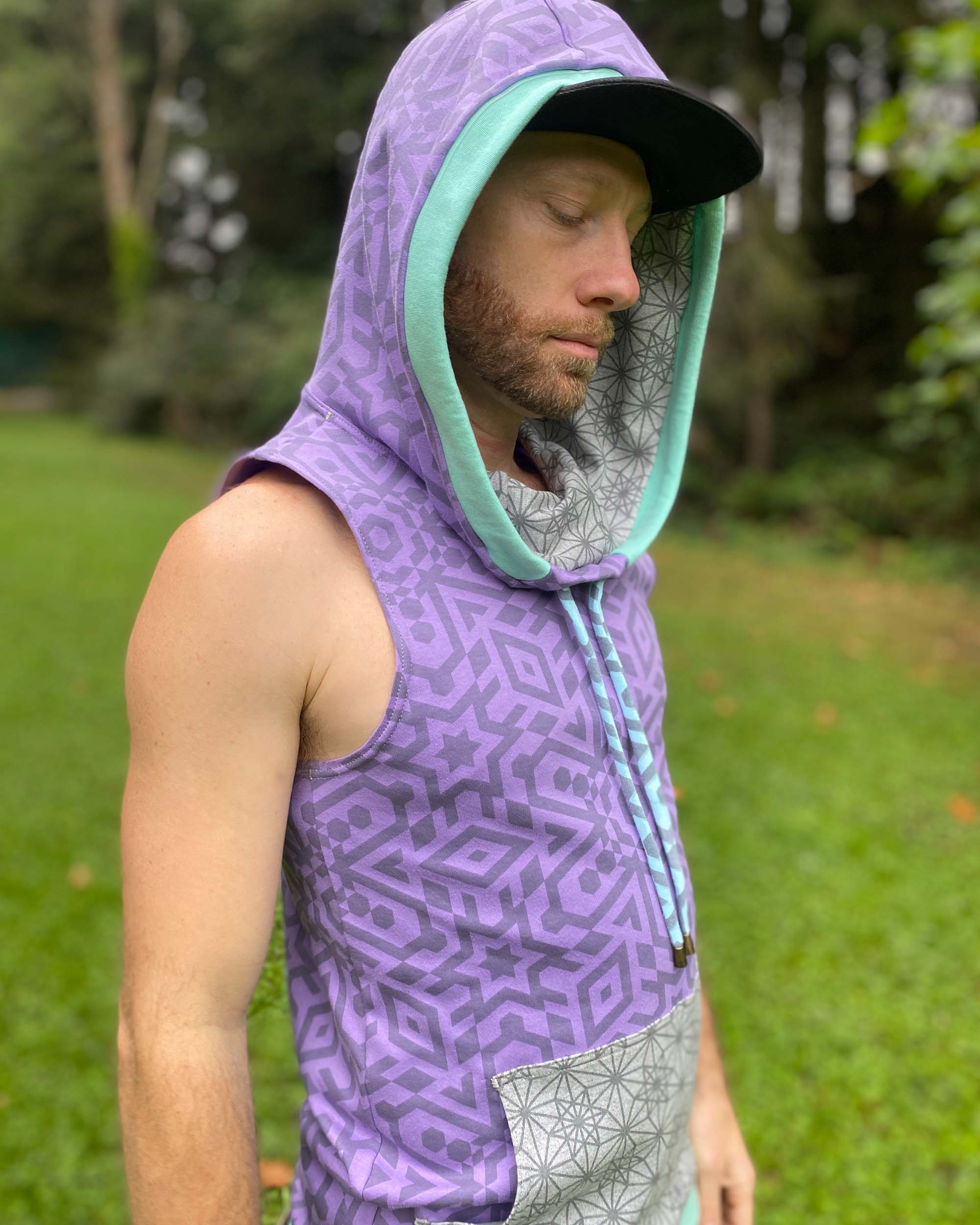 Organic cotton hooded tank top, lavender with geometric print, right side view on male model.