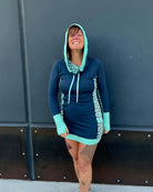 Organic cotton hooded tunic dress, blue with sacred geometry fabric accents, front view on model.