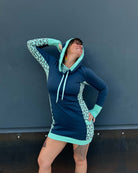 Organic cotton hooded tunic dress, blue and mint geometric mint fabric, front view on model.