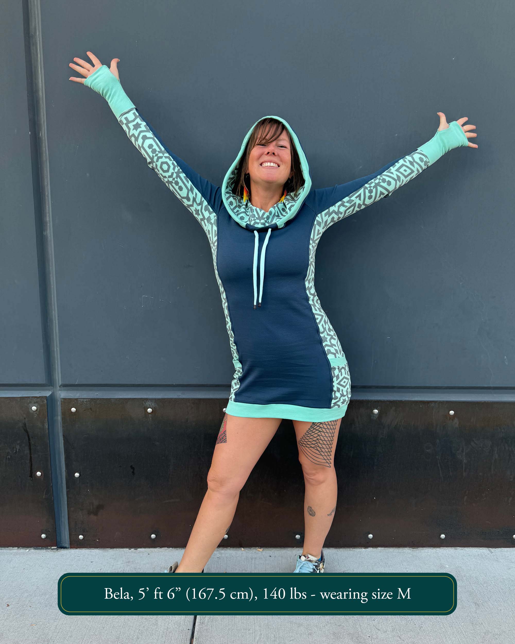 Organic cotton hooded tunic dress, blue with geometric mint fabric accents, front view on model.