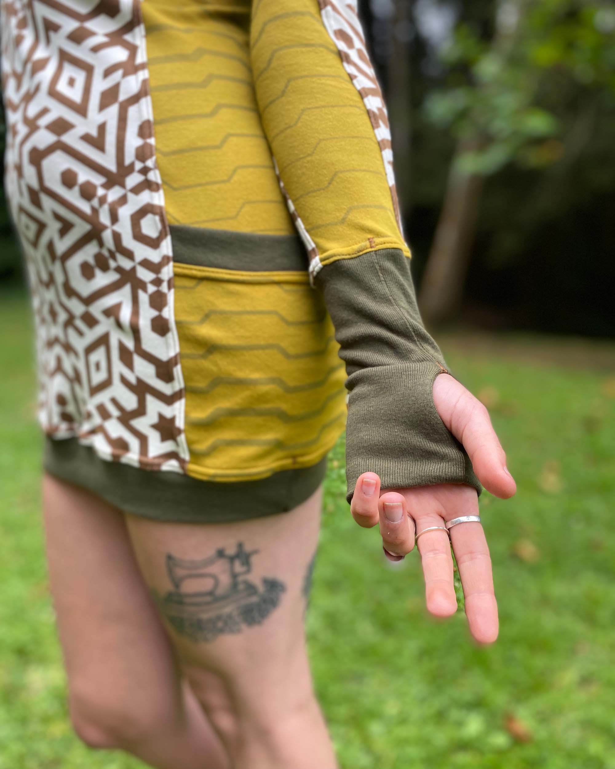 Organic cotton tunic dress, undyed fabric with brown geo print, close up view of cuff.