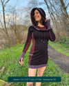 Organic cotton hooded tunic dress, black with geometric brown fabric accents, front view on model.
