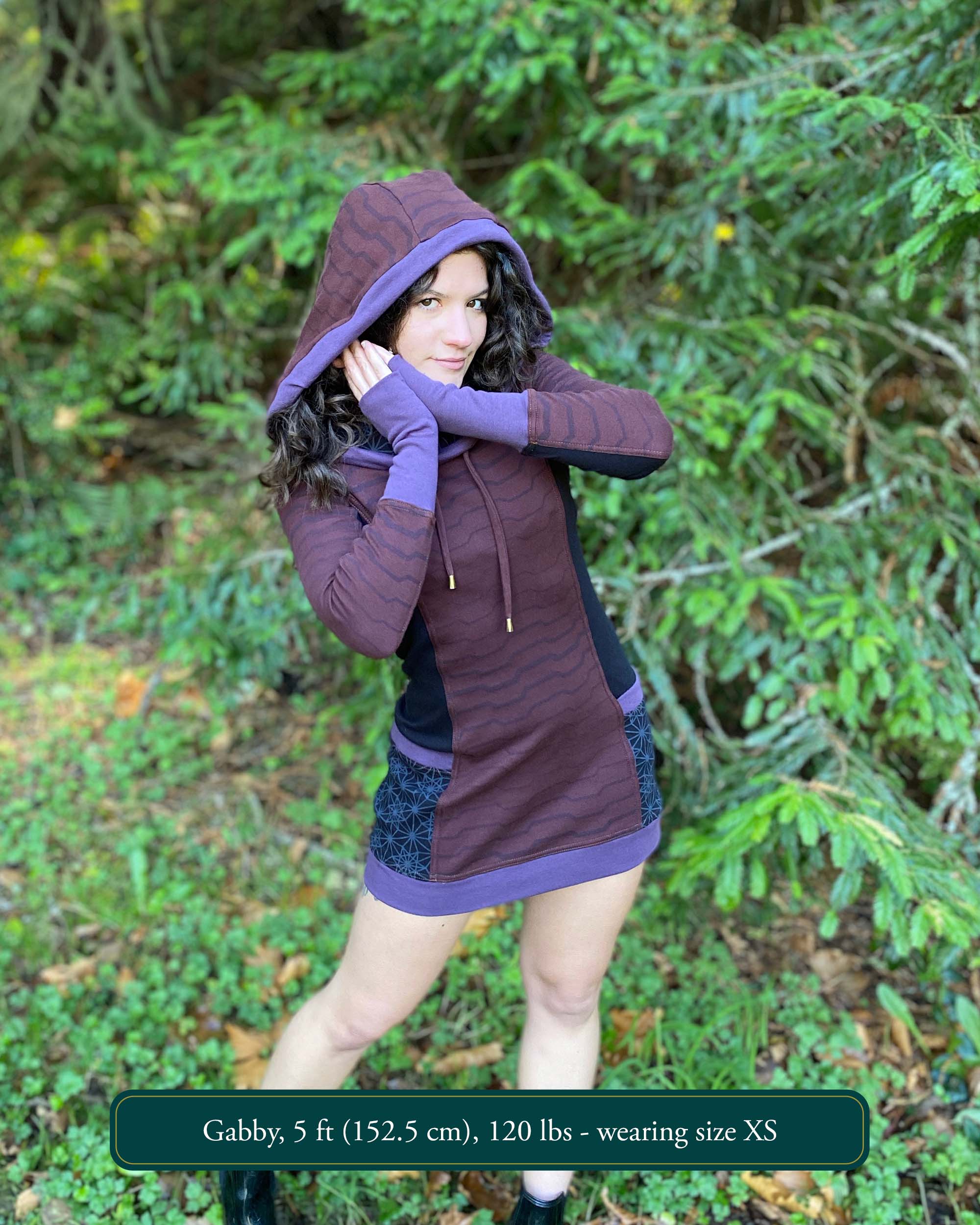 Organic cotton hooded tunic dress, reddish brown with geometric print, front view on model.