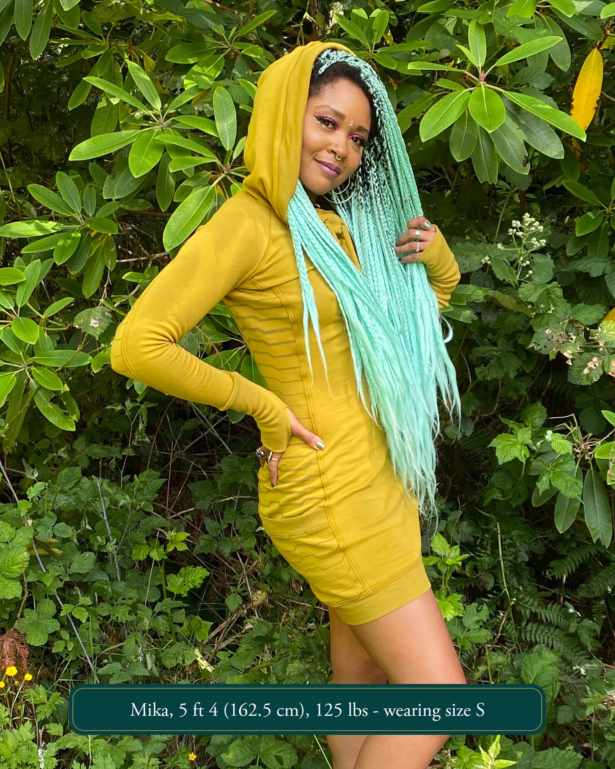Organic cotton hooded tunic dress, yellow fabric with geometric print, right side view on model.