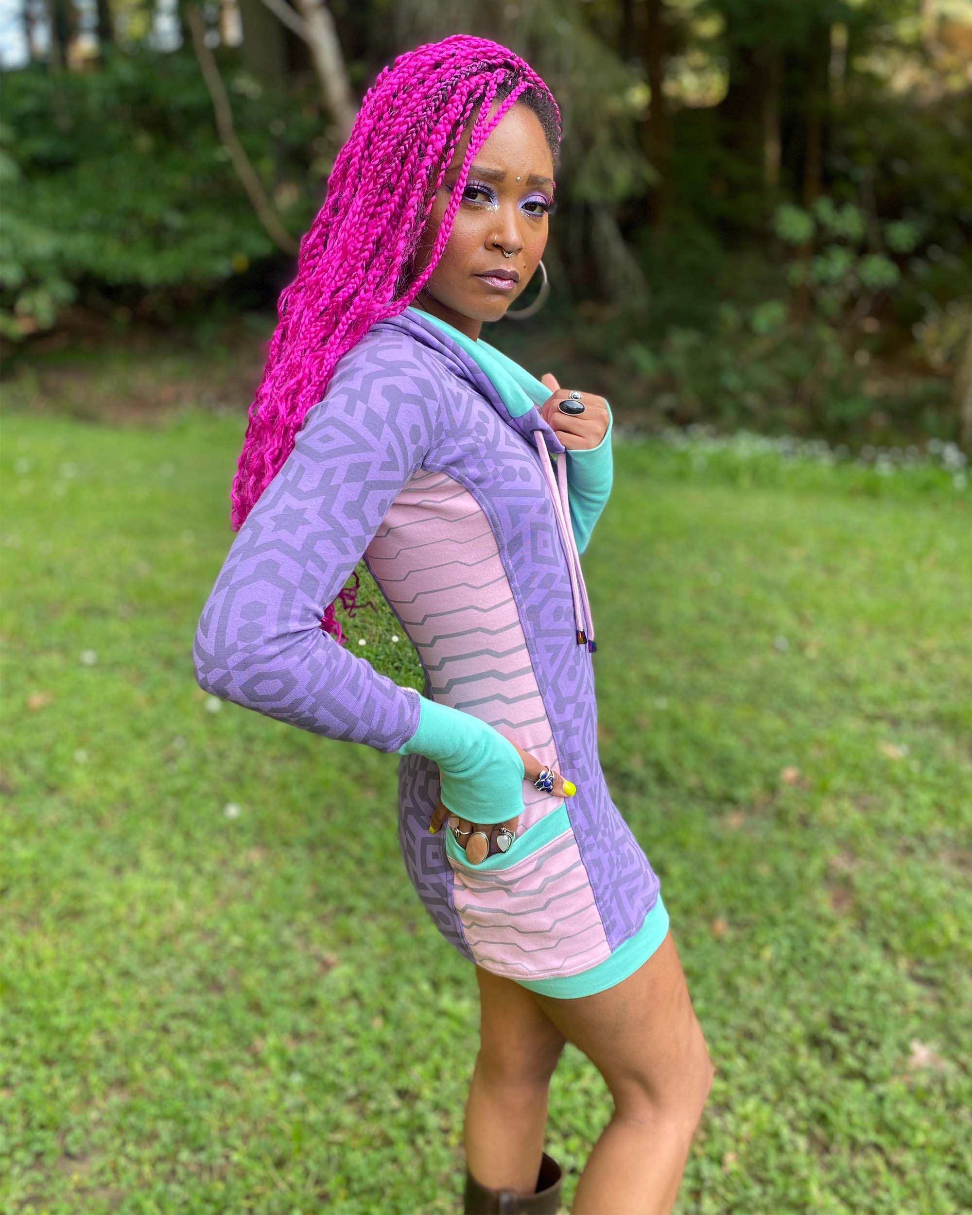 Organic cotton hooded tunic dress, lavender and pink fabric with geometric print, right side view on model.