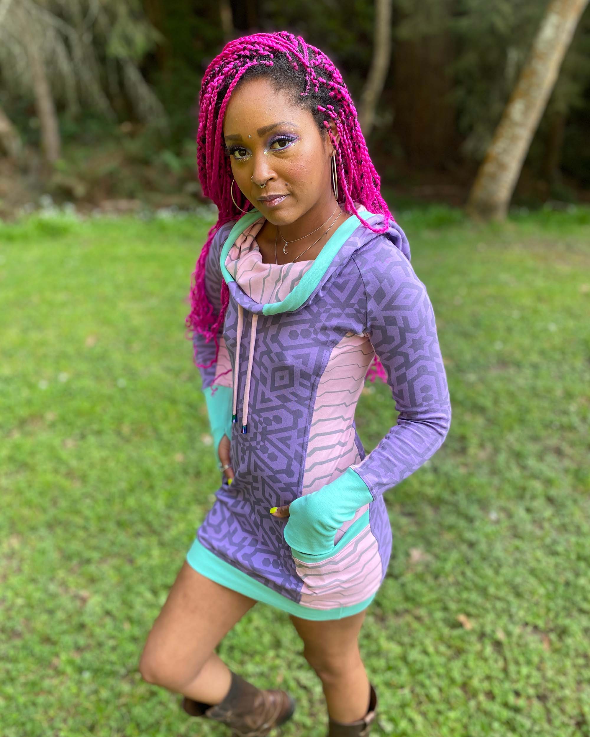 Organic cotton hooded tunic dress, lavender and pink fabric with geometric print, top front view on model.