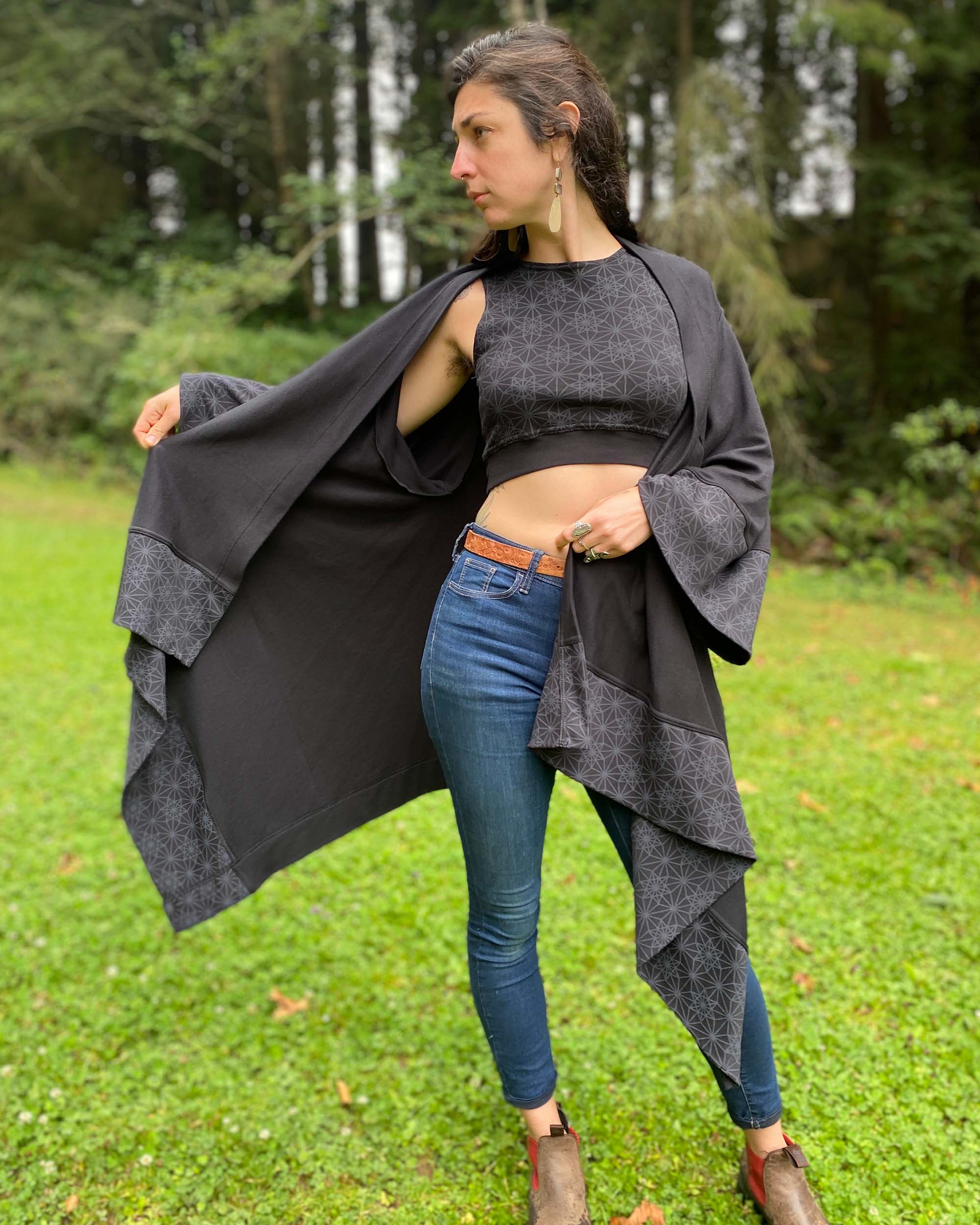 Organic cotton kimono, black with geometric printed fabric accents, front view on female model.