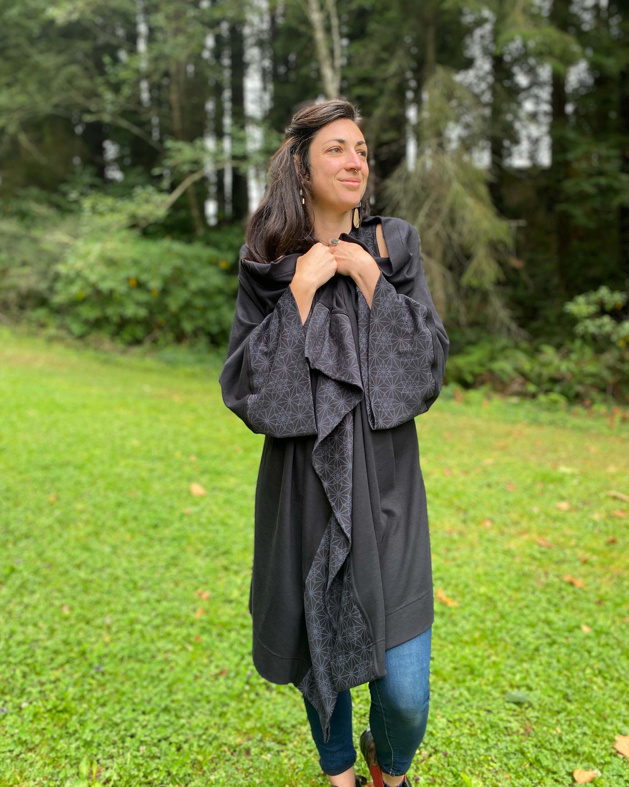Organic cotton kimono, black with geometric printed accents, front view of female model.