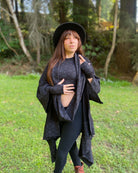 Organic cotton kimono, black with geo print fabric, front right side view on female model with matching garments.