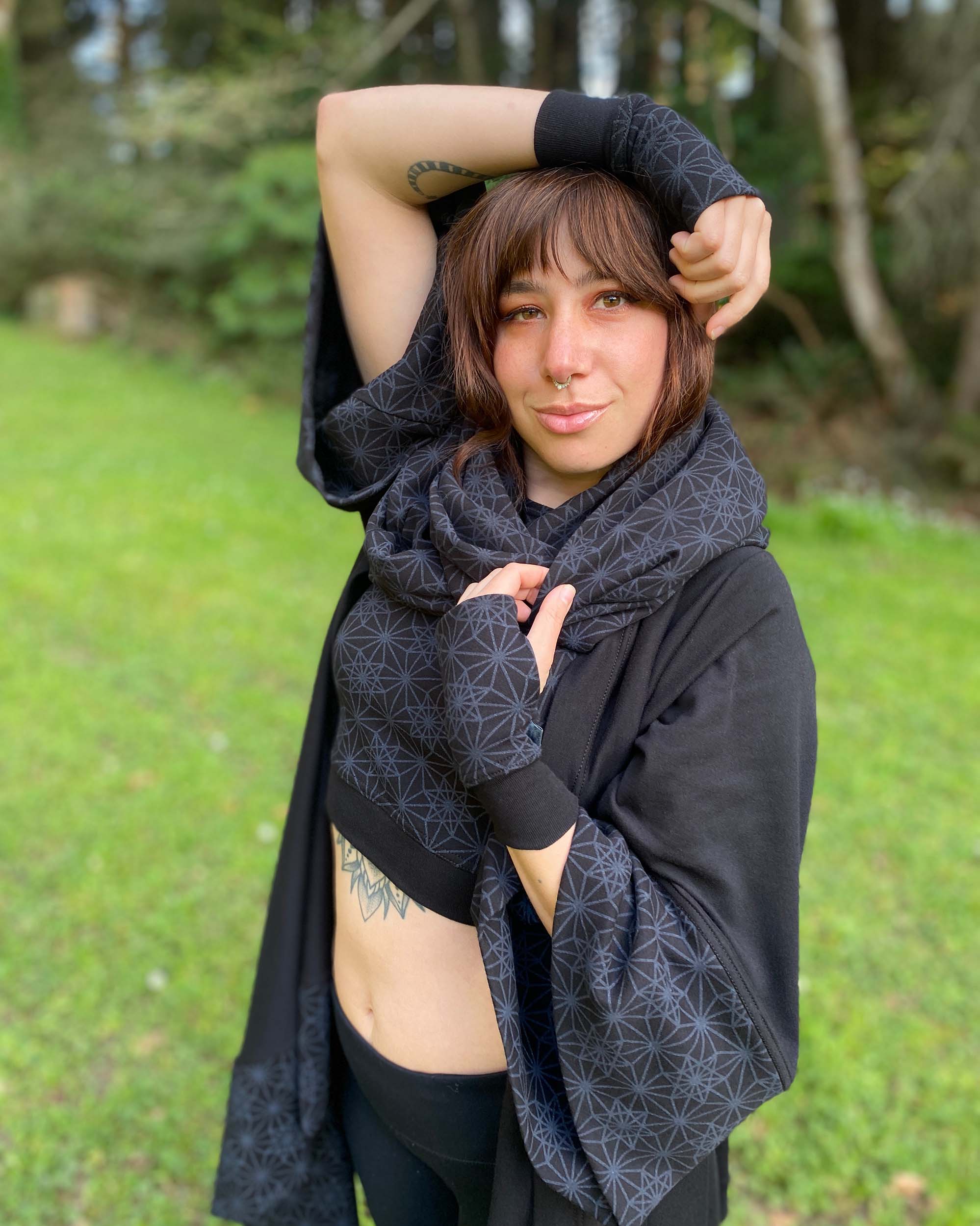 Organic cotton kimono, black with geometric print, front left side view on female model.