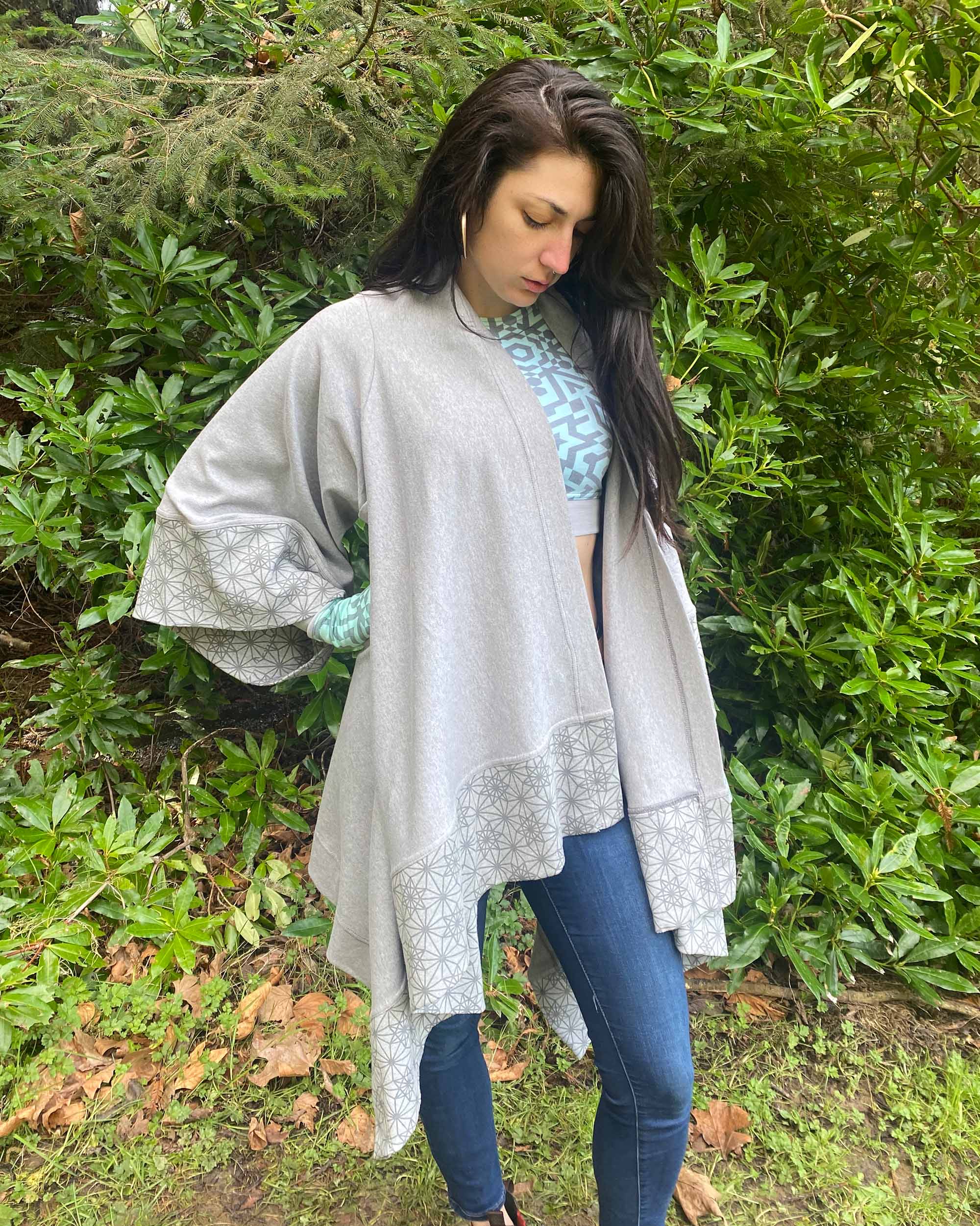 Organic cotton kimono, grey fabric with geometric print accents, front view on female model in natural lighting.