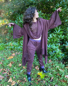 Organic cotton kimono, reddish brown fabric with geo printed accents, front view on female model.