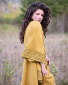 Organic cotton kimono, yellow fabric with geometric print accents, right side detail view.