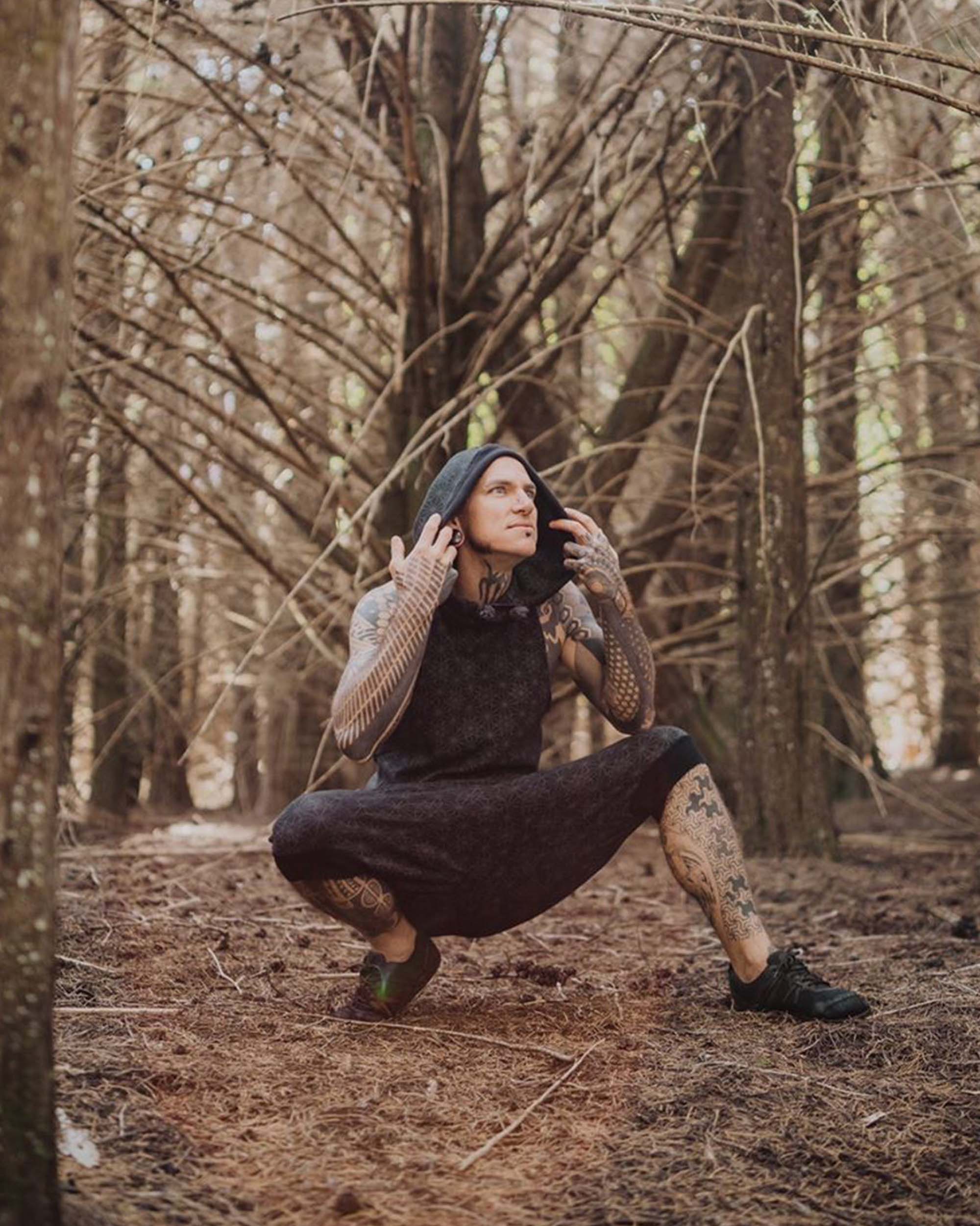 Organic cotton matching hooded tank top and shorts, black fabric with geometric print, worn by male model.