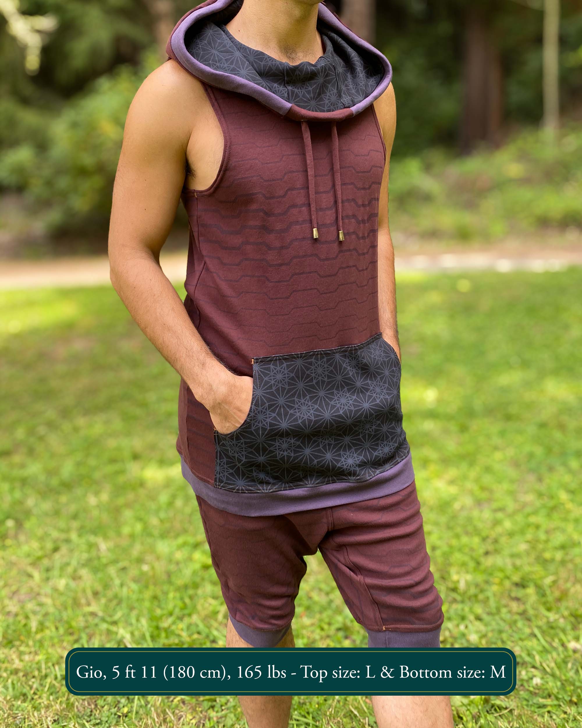 Cowl hood tank top and drop crotch shorts, brown fabric with geometric stripes, front right view on male model.
