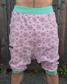 Organic cotton drop crotch shorts, pink with geometric fabric print, front view on model.