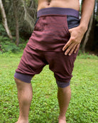 Organic cotton drop crotch shorts, brown fabric with geometric print, front right view on model.  