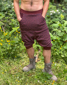 Organic cotton drop crotch shorts, brown fabric with geometric print, front view on male model.