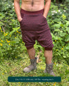 Organic cotton drop crotch shorts, brown fabric with sacred geometry print, front view on male model.