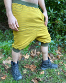 Organic cotton drop crotch shorts, yellow fabric with stripe print, right side view on male model.