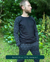 Organic cotton long sleeve shirt, black with geometric sleeve prints, front right side view on male model.