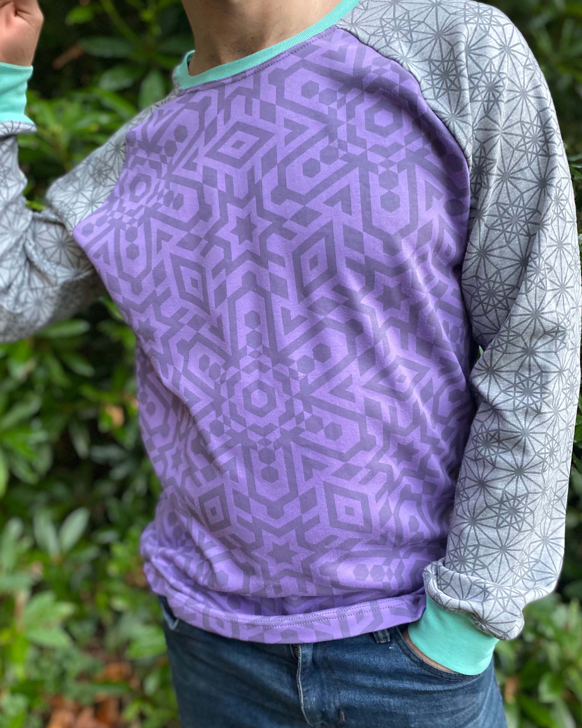 Organic cotton long sleeve shirt, lavender torso with grey geometric sleeves, detail view of fabric.