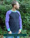 Organic cotton long sleeve shirt, black with lavender geometric sleeve print, front view on model.