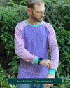 Organic cotton long sleeve shirt, lavender with pink geometric striped sleeves, front view on model.