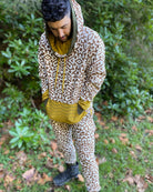 Men's matching two piece sweatsuit, brown geo printed organic fabric, front view, worn on male model.