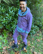 Men's matching two piece sweatsuit, lavender fabric with geometric print, left side view on male model.