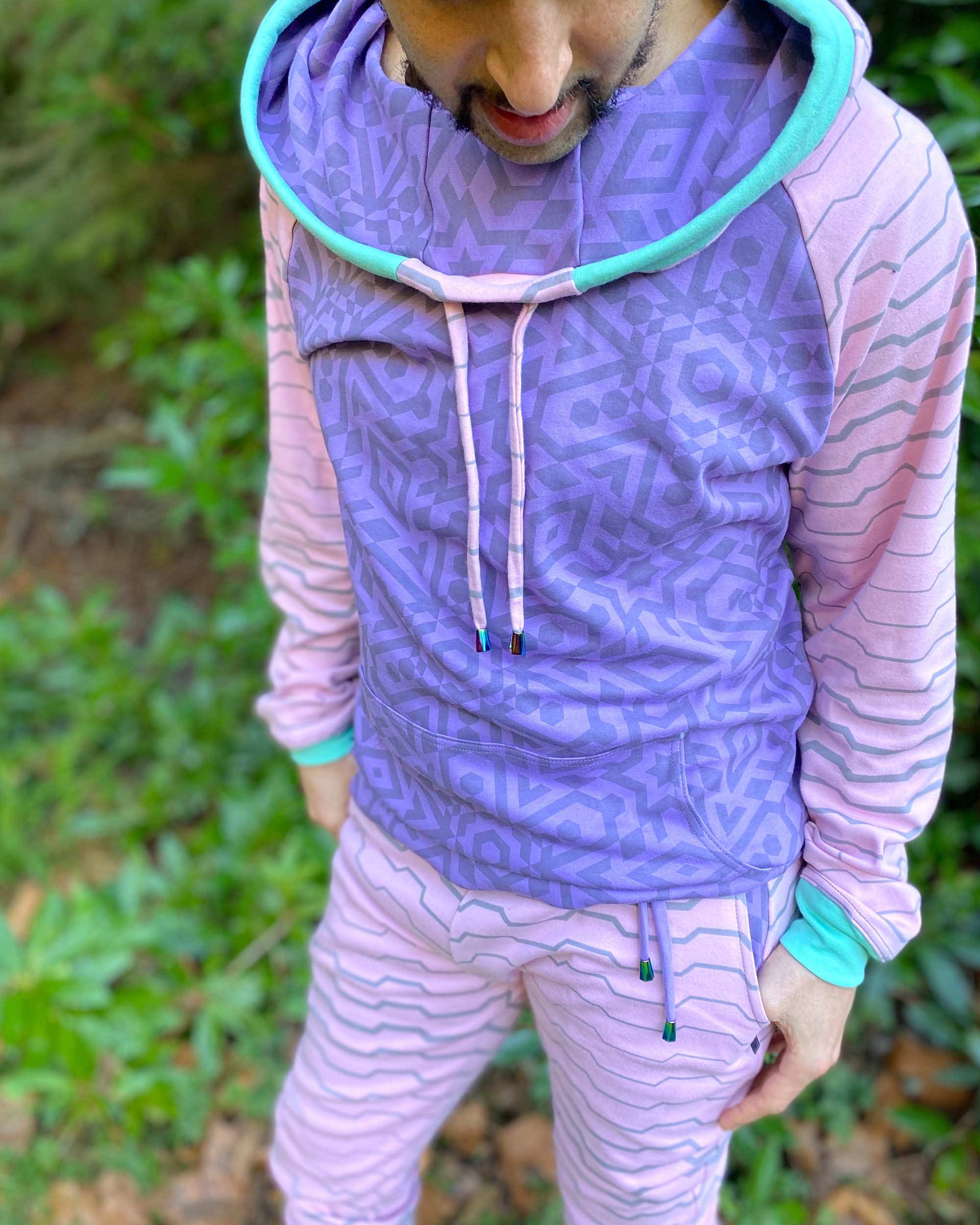 Men's matching two piece sweatsuit, pink and purple fabric, geometric print, detail view of fabric.