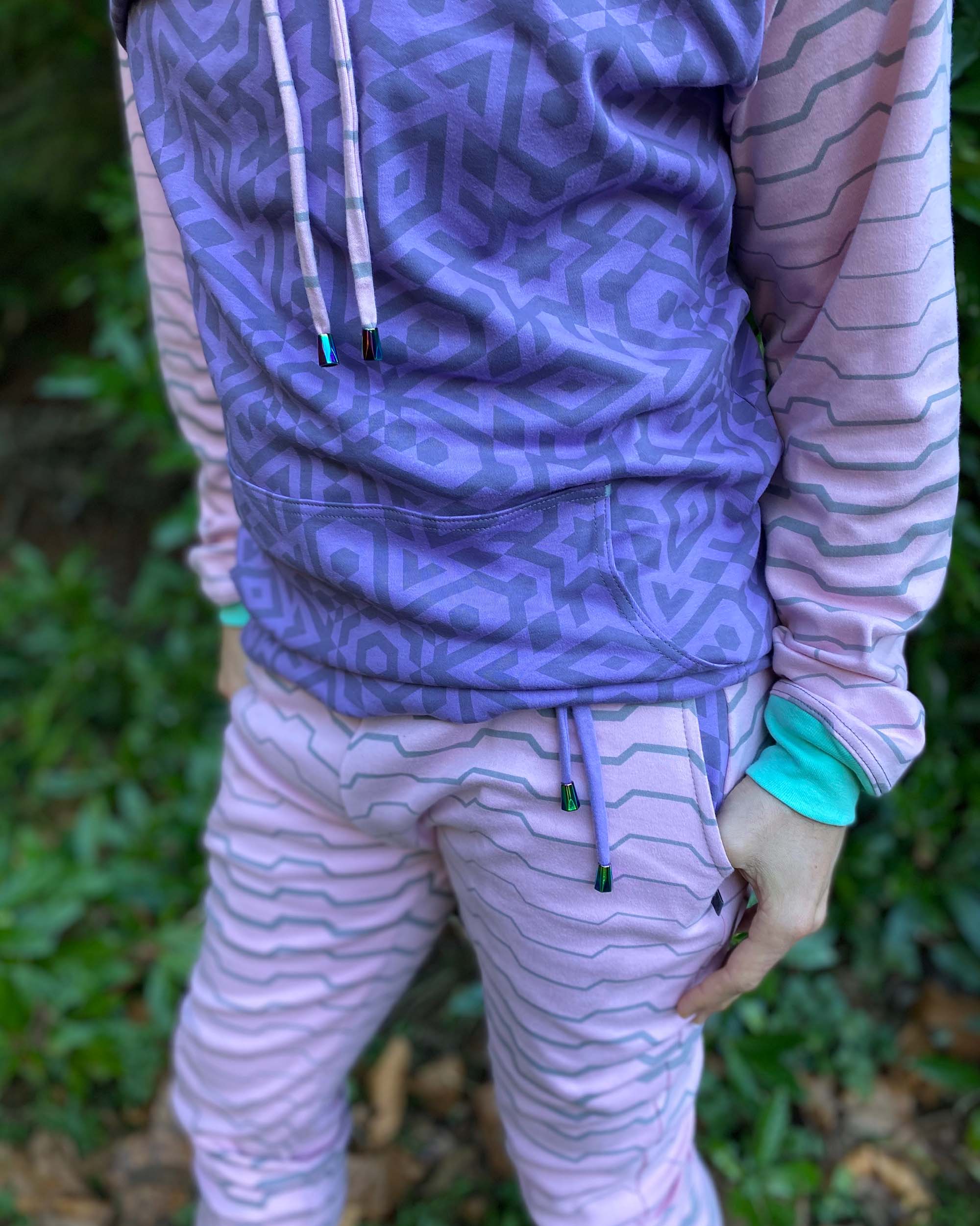 Men's matching two piece sweatsuit, pink and purple fabric, geometric print, detail view of pockets.