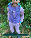 Men's matching two piece sweatsuit, pink and purple geometric printed fabric, front view on model.