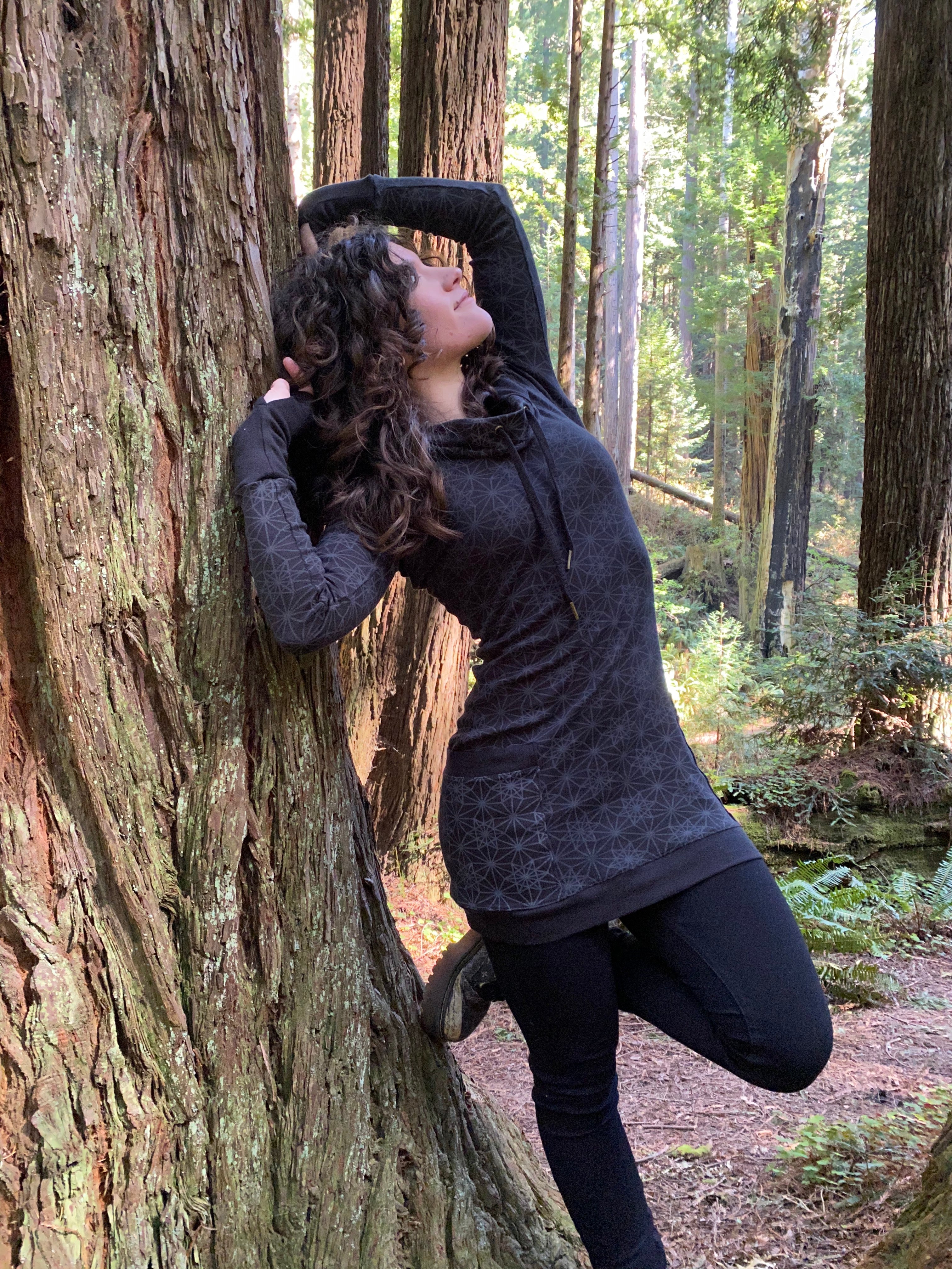 Women's long sleeve black festival hoodie dress with pockets made in the USA from organic cotton. Sacred geometry print.