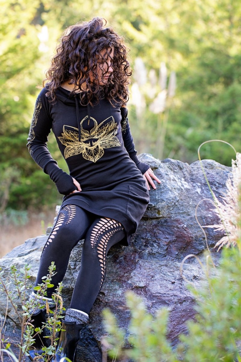 Black hooded dress with gold lotus flower print and pockets. Deep cowl hood. Organic cotton festival wear made in the USA.